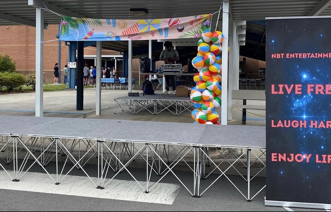 NBT Entertainment DJ setup at an outdoor school event with beach ball decor