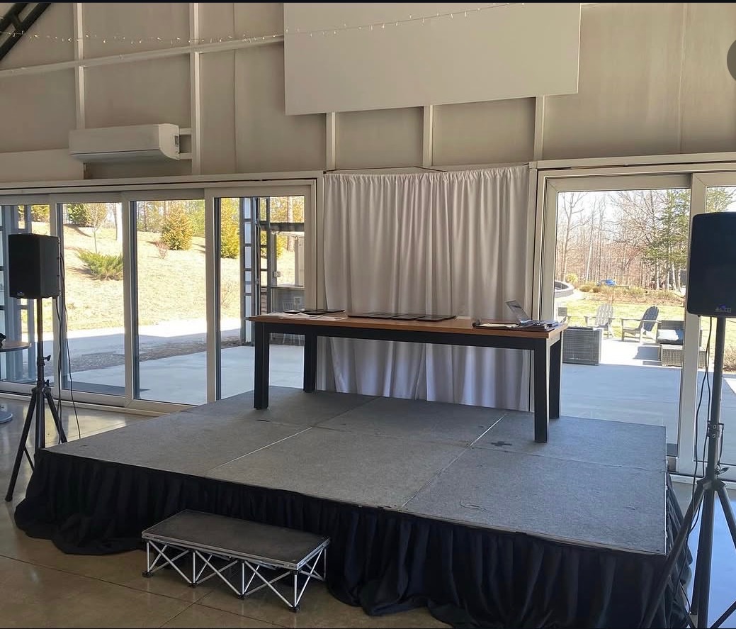 NBT Entertainment stage and DJ setup inside a bright event venue
