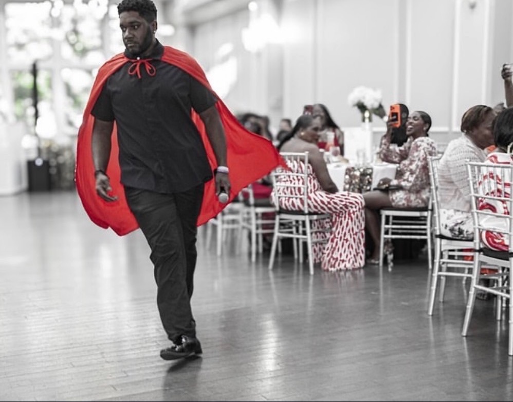 NBT Entertainment host with red cape entertaining guests at a reception