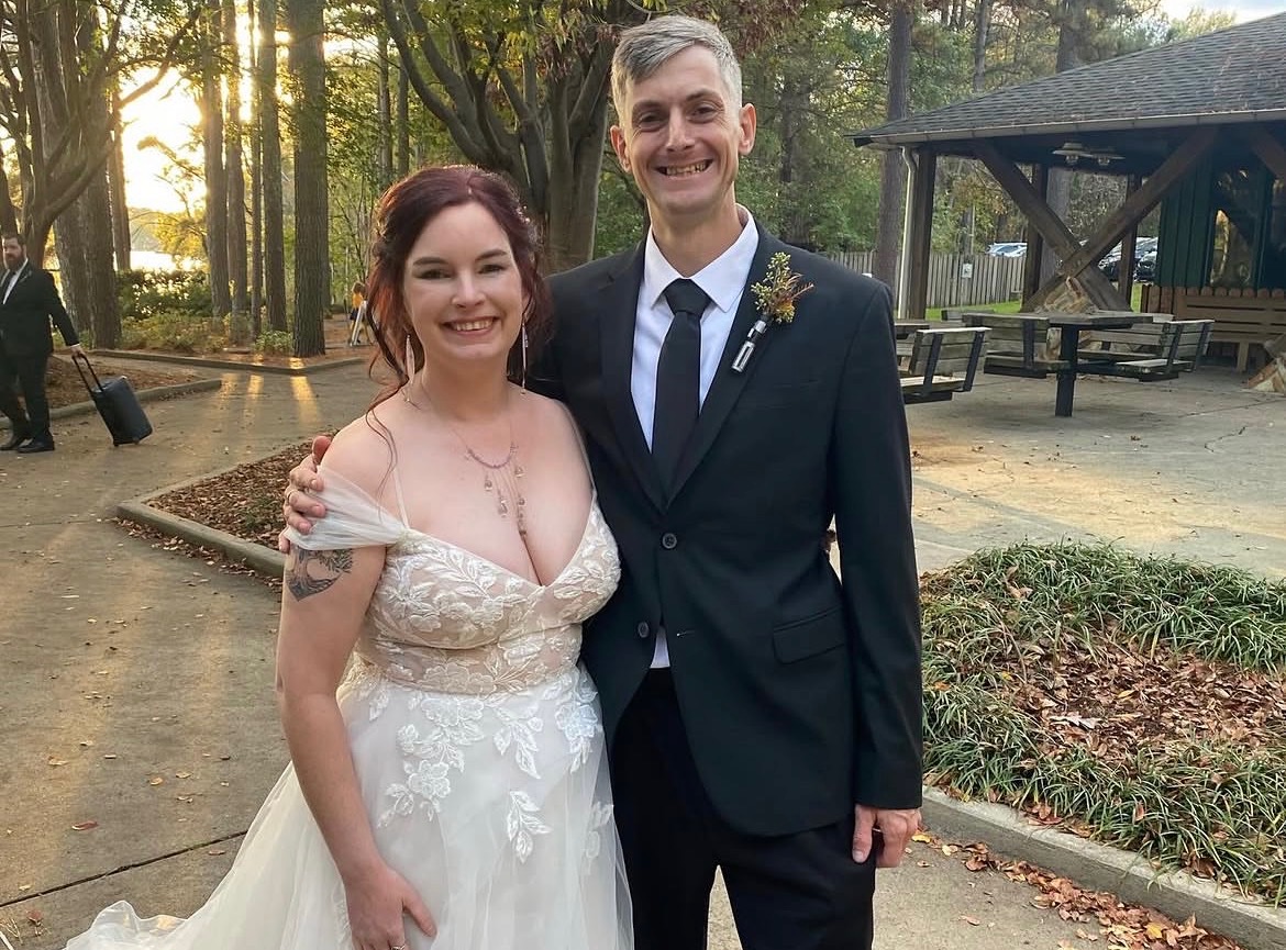 Bride and groom smiling outdoors after their wedding ceremony
