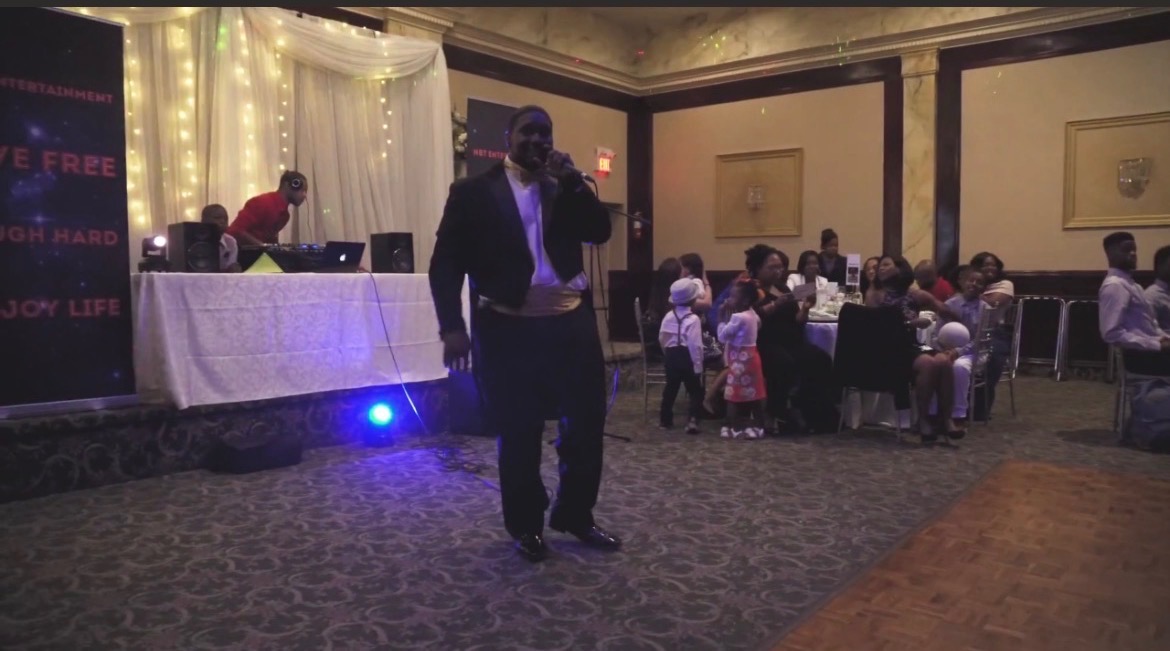 NBT Entertainment host on the mic at an elegant banquet event