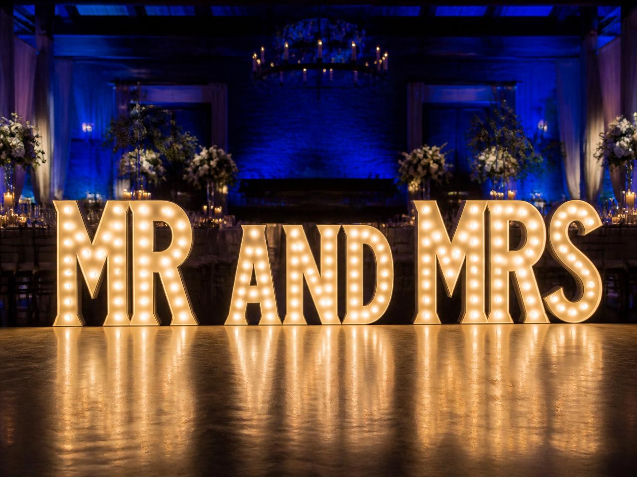 Four foot tall light up marquee letters spelling MR AND MRS at an evening wedding reception